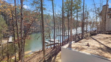 Welcome to 1040 Sunrise Court, a stunning new construction on Reynolds Lake Oconee - The Oconee in Georgia - for sale on GolfHomes.com, golf home, golf lot