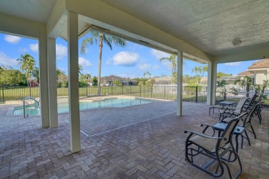 This former model home offers breathtaking lake and golf course on The Wanderers Club in Florida - for sale on GolfHomes.com, golf home, golf lot