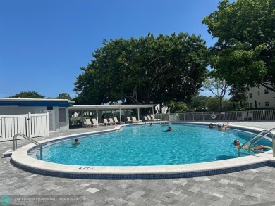 This condo has it all- tile throughout- new appliances - newer on Hillsboro Pines Golf in Florida - for sale on GolfHomes.com, golf home, golf lot