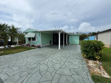 This immaculate, well-maintained 2 bedroom/2 bath manufactured on Lake Henry Golf Club in Florida - for sale on GolfHomes.com, golf home, golf lot