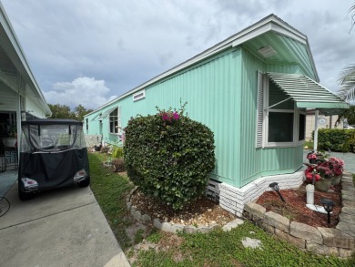 This immaculate, well-maintained 2 bedroom/2 bath manufactured on Lake Henry Golf Club in Florida - for sale on GolfHomes.com, golf home, golf lot