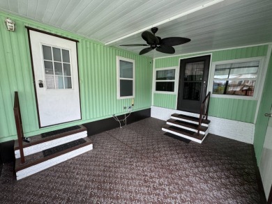 This immaculate, well-maintained 2 bedroom/2 bath manufactured on Lake Henry Golf Club in Florida - for sale on GolfHomes.com, golf home, golf lot