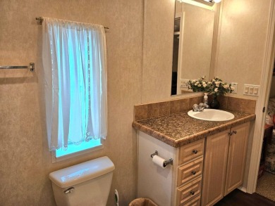 This 2 bedroom, 2 bath has approximately 1000 feet of living on Southport Springs Golf Club in Florida - for sale on GolfHomes.com, golf home, golf lot