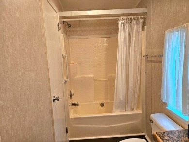 This 2 bedroom, 2 bath has approximately 1000 feet of living on Southport Springs Golf Club in Florida - for sale on GolfHomes.com, golf home, golf lot