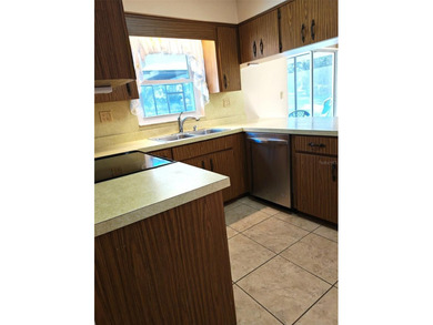 Move in ready pool home with 2 bedrooms, 1 & 1/2 baths & 1 car on Sherman Hills Golf Club in Florida - for sale on GolfHomes.com, golf home, golf lot