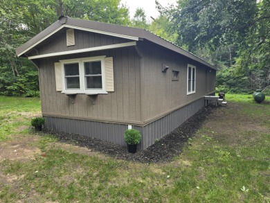 Own Your Up-North Escape! Why rent when you can own this on Lakes of the North Deer Run Golf Course in Michigan - for sale on GolfHomes.com, golf home, golf lot