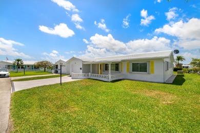 Nestled within 55+ Palm Beach Leisureville, this expanded on Leisureville Community Golf Course in Florida - for sale on GolfHomes.com, golf home, golf lot