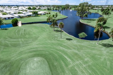 Nestled within 55+ Palm Beach Leisureville, this expanded on Leisureville Community Golf Course in Florida - for sale on GolfHomes.com, golf home, golf lot