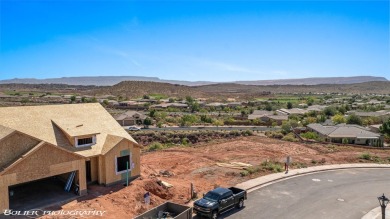 Experience breathtaking views of the city, mountains, and golf on Coral Canyon Golf Course in Utah - for sale on GolfHomes.com, golf home, golf lot