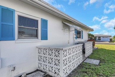 The oversized covered front porch welcomes you into this on Mainlands Golf Club in Florida - for sale on GolfHomes.com, golf home, golf lot