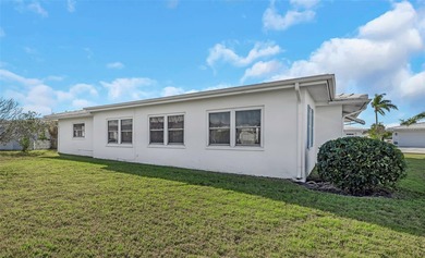 The oversized covered front porch welcomes you into this on Mainlands Golf Club in Florida - for sale on GolfHomes.com, golf home, golf lot