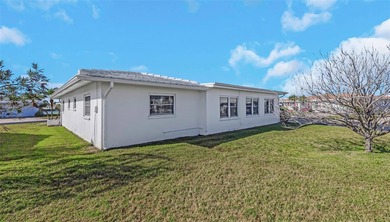 The oversized covered front porch welcomes you into this on Mainlands Golf Club in Florida - for sale on GolfHomes.com, golf home, golf lot