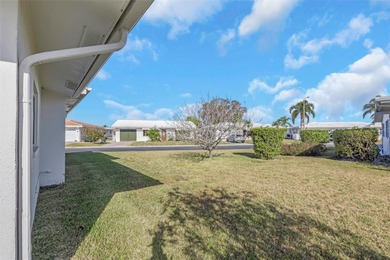 The oversized covered front porch welcomes you into this on Mainlands Golf Club in Florida - for sale on GolfHomes.com, golf home, golf lot