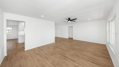 The oversized covered front porch welcomes you into this on Mainlands Golf Club in Florida - for sale on GolfHomes.com, golf home, golf lot