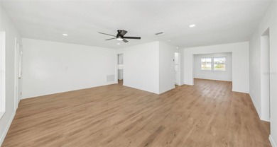 The oversized covered front porch welcomes you into this on Mainlands Golf Club in Florida - for sale on GolfHomes.com, golf home, golf lot