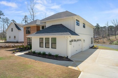 Discover this stunning new construction perched directly on on Harbor Club Golf and Country Club in Georgia - for sale on GolfHomes.com, golf home, golf lot