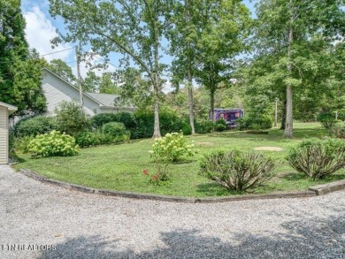 Lakefront Home with Detached Garage and Covered Boat Dock.  Step on Lake Tansi Village Country Club in Tennessee - for sale on GolfHomes.com, golf home, golf lot