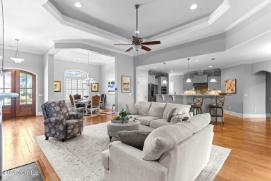 This home boasts captivating sunset views over the 3rd hole of on Cape Fear National At Brunswick Forest in North Carolina - for sale on GolfHomes.com, golf home, golf lot