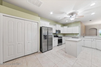 Live the good life in this upscale lakefront villa in Viera on Viera East Golf Club in Florida - for sale on GolfHomes.com, golf home, golf lot