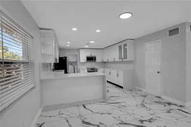 Discover this beautifully renovated 4-bedroom, 3-bath,  dream on Temple Terrace Golf and Country Club in Florida - for sale on GolfHomes.com, golf home, golf lot