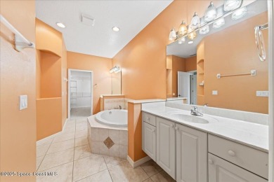 Live the good life in this upscale lakefront villa in Viera on Viera East Golf Club in Florida - for sale on GolfHomes.com, golf home, golf lot