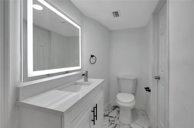 Discover this beautifully renovated 4-bedroom, 3-bath,  dream on Temple Terrace Golf and Country Club in Florida - for sale on GolfHomes.com, golf home, golf lot