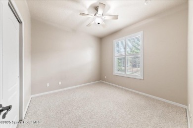 Live the good life in this upscale lakefront villa in Viera on Viera East Golf Club in Florida - for sale on GolfHomes.com, golf home, golf lot