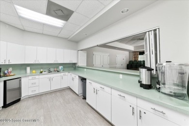 Live the good life in this upscale lakefront villa in Viera on Viera East Golf Club in Florida - for sale on GolfHomes.com, golf home, golf lot