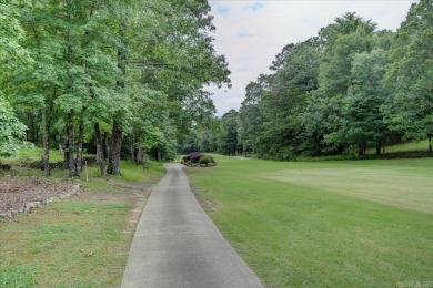 As you arrive at 208 Pebble Beach, the meticulously manicured on Diamondhead Golf and Country Club in Arkansas - for sale on GolfHomes.com, golf home, golf lot