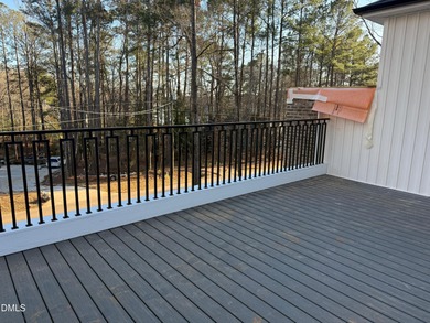 Stunning modern new construction in the gated lake community of on River Golf and Country Club at Lake Royale in North Carolina - for sale on GolfHomes.com, golf home, golf lot