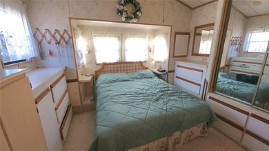 ENJOY THE WATER VIEW FROM THIS TWO BEDROOM 1 1/2 BATH MOBILE on River Run Golf Links in Florida - for sale on GolfHomes.com, golf home, golf lot