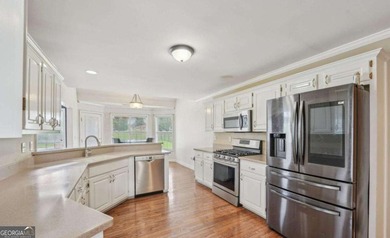 Welcome home to this beautiful all-brick ranch in the on Canongate At Georgia National Golf Club in Georgia - for sale on GolfHomes.com, golf home, golf lot