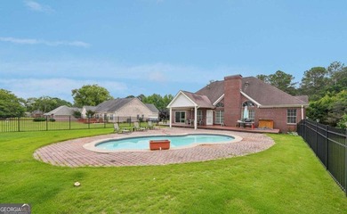 Welcome home to this beautiful all-brick ranch in the on Canongate At Georgia National Golf Club in Georgia - for sale on GolfHomes.com, golf home, golf lot