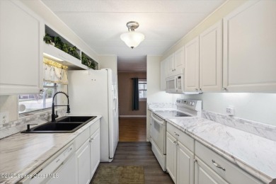 Welcome to Barefoot Bay! This 2 bedroom, 2 bath home is walking on Barefoot Bay Golf Course in Florida - for sale on GolfHomes.com, golf home, golf lot