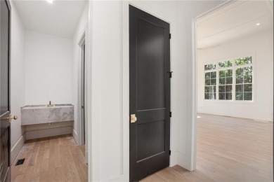 Set on a sprawling 1-acre lot in an established, tree-lined on Dunwoody Country Club in Georgia - for sale on GolfHomes.com, golf home, golf lot