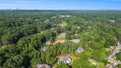 Set on a sprawling 1-acre lot in an established, tree-lined on Dunwoody Country Club in Georgia - for sale on GolfHomes.com, golf home, golf lot