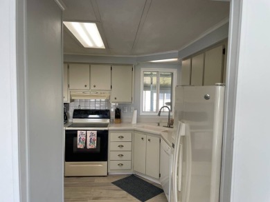 TIRED OF SNOW,ICE AND COLD, TRADE IT IN FOR SUN,WARM AND WHITE on Lake Fairways Country Club in Florida - for sale on GolfHomes.com, golf home, golf lot