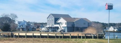 Breathtaking views of the Chincoteague Bay, a front row seat to on Captains Cove Golf and Yacht Club in Virginia - for sale on GolfHomes.com, golf home, golf lot