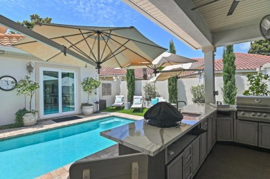 Step into a home that feels like a private resort--where indoor on Regatta Bay Golf and Country Club in Florida - for sale on GolfHomes.com, golf home, golf lot