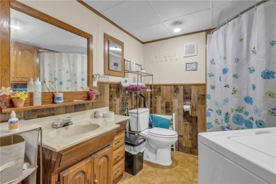 Enjoy lakeside living with this charming and move-in ready cabin on Sugar Valley Lakes Golf Course in Kansas - for sale on GolfHomes.com, golf home, golf lot