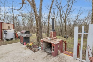 Enjoy lakeside living with this charming and move-in ready cabin on Sugar Valley Lakes Golf Course in Kansas - for sale on GolfHomes.com, golf home, golf lot