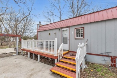Enjoy lakeside living with this charming and move-in ready cabin on Sugar Valley Lakes Golf Course in Kansas - for sale on GolfHomes.com, golf home, golf lot