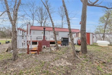 Enjoy lakeside living with this charming and move-in ready cabin on Sugar Valley Lakes Golf Course in Kansas - for sale on GolfHomes.com, golf home, golf lot