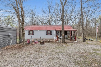 Enjoy lakeside living with this charming and move-in ready cabin on Sugar Valley Lakes Golf Course in Kansas - for sale on GolfHomes.com, golf home, golf lot