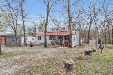 Enjoy lakeside living with this charming and move-in ready cabin on Sugar Valley Lakes Golf Course in Kansas - for sale on GolfHomes.com, golf home, golf lot