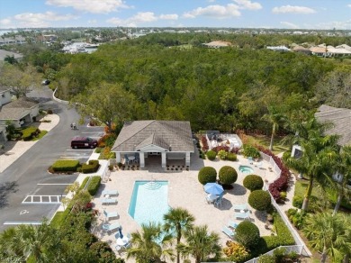 Nicely appointed first floor coach home located directly across on Windstar on Naples Bay in Florida - for sale on GolfHomes.com, golf home, golf lot