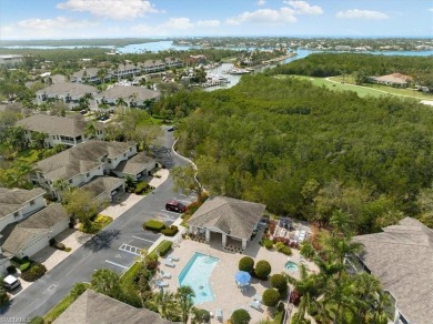 Nicely appointed first floor coach home located directly across on Windstar on Naples Bay in Florida - for sale on GolfHomes.com, golf home, golf lot