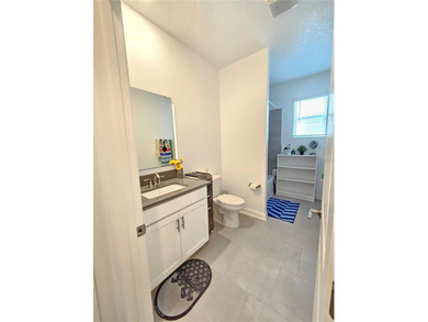 Built in 2024, this 4 bedroom / 3 bathroom Newcastle model on The Oasis Club at Champions Gate in Florida - for sale on GolfHomes.com, golf home, golf lot