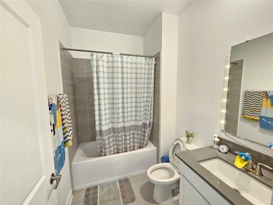 Built in 2024, this 4 bedroom / 3 bathroom Newcastle model on The Oasis Club at Champions Gate in Florida - for sale on GolfHomes.com, golf home, golf lot