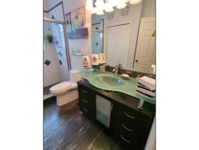 Welcome to this charming 3-bedroom, 2-bathroom WATERFRONT home on East Lake Woodlands Country Club in Florida - for sale on GolfHomes.com, golf home, golf lot
